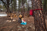 Dog Tether used in campsite with a person and a dog, showcasing Ruffwear Knot-a-Hitch system.